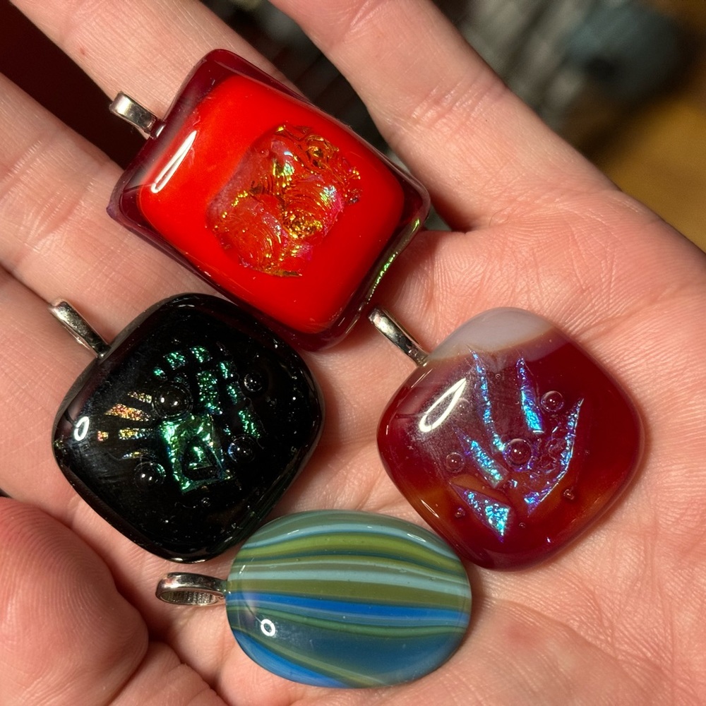 4 fused glass pendants.